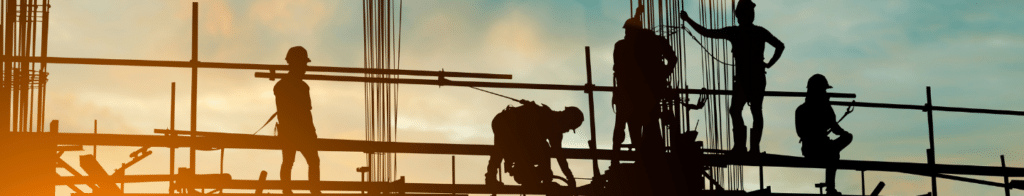 Contractor silhouettes on scaffolding